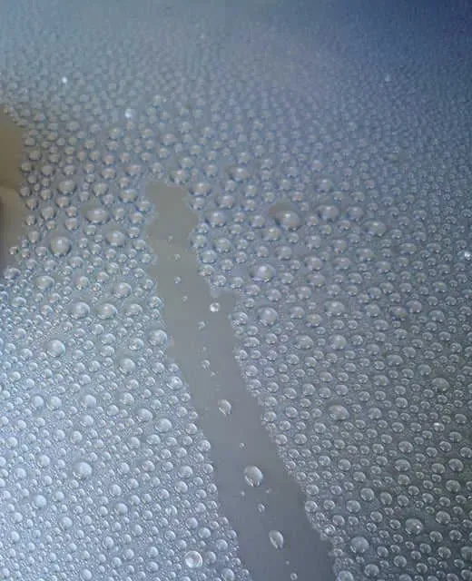 Wasser perlt auf versiegeltem Autolack ab